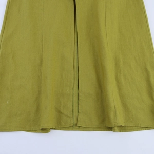 Detail showing high-quality mustard yellow cotton-linen fabric texture and stitching seam