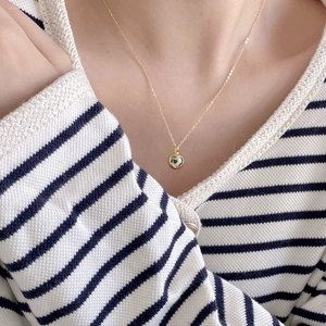 Close-up of 925 sterling silver heart necklace with spotted zebra stone on a model