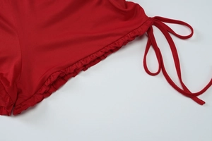 Detail of red summer set featuring ruffled edges and adjustable drawstring waist cord