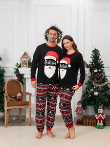 Cozy Christmas pajamas detail with Believe print and festive reindeer pattern pants
