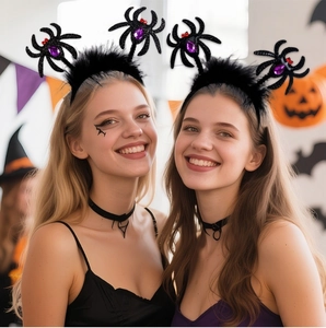 Black spider headband with purple gems and feathers worn by models at a party