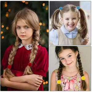 Multiple colorful faux fur pom-pom hair ties shown on a young girl's braided hairstyle