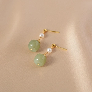 Vintage freshwater pearl and jade drop earrings with gold studs on silk fabric