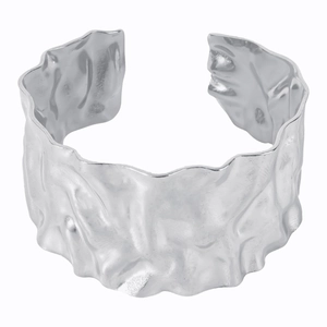 Detailed view of wide cuff bracelet featuring a unique crumpled and hammered silver texture