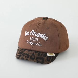 Detail of suede baseball cap featuring embroidered letters and leopard print brim