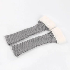 Detail of grey ribbed knit leg warmers with plush white faux fur cuffs and soft texture