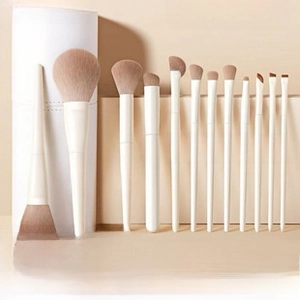 Detailed view of 12-piece pearl white makeup brush set with elegant cylinder case