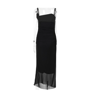 Detail view of the black slip dress showing pleated waist texture and sheer mesh hemline