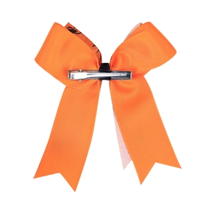 Close-up of Halloween orange grosgrain ribbon bow with black center and metal clip