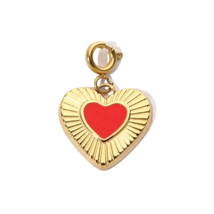 Detail of red enamel heart pendant with golden finish and spring clasp attachment