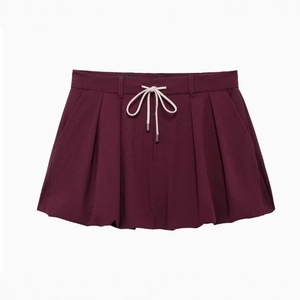 Burgundy pleated mini skirt with cream drawstring waist in a flat lay front view