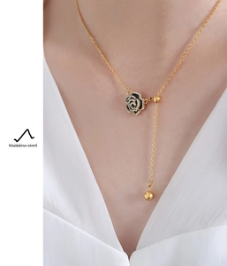 Detail of a rose pendant on a gold stainless steel Y-necklace with micro-set crystals