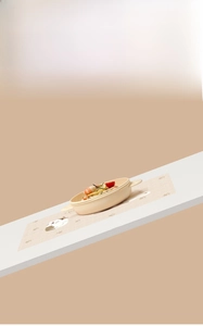 Detail of disposable baby placemat with cartoon cat pattern and silicone suction bowl set