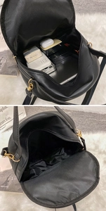 Interior view of black quilted mini bag showing storage capacity for phone and accessories