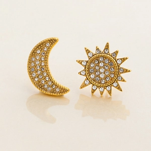 Macro shot of 18K gold-plated stainless steel sun and moon earrings with white crystals