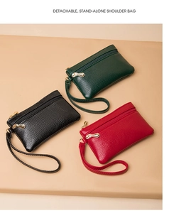 Three leather mini wallets in green, black, and red with gold zippers and wrist straps