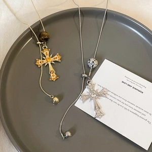 Tiger eye stone cross pendant necklaces in gold and silver finish on a display tray