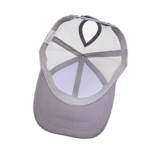 Detail of grey trucker hat featuring a ponytail hole and breathable mesh panels