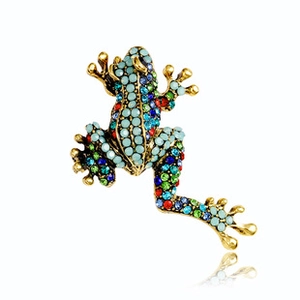 Detailed view of frog brooch with turquoise stones and colorful rhinestones on gold base