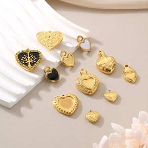 Detailed view of various gold heart pendants with embossed patterns and tree of life motifs