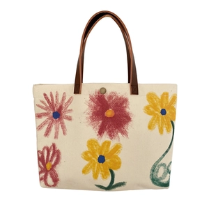 Floral canvas tote bag with brown leather handles and graffiti flower print design