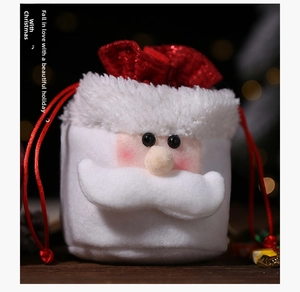 Detail of burlap Christmas gift bag with Santa Claus face and red drawstrings