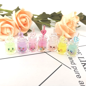 Set of seven colorful mini glow-in-the-dark resin drink bottles with cute expressions