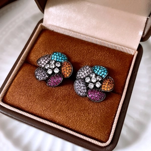 Close-up of colorful floral earrings with multi-colored zirconia in a brown velvet box