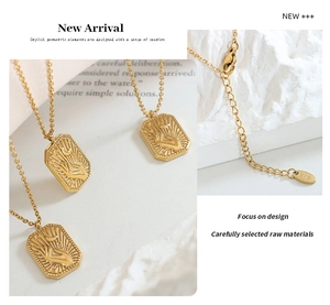 Detailed close-up of gold square moon pendant with K18 engraved clasp and extension chain