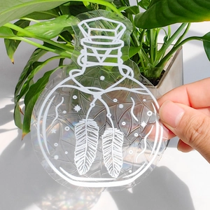 Detail shot of rainbow suncatcher sticker with magic potion and feather design