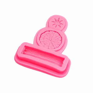 Pink silicone mold featuring star anise and citrus slice patterns for festive cake decorating