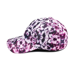 Side view of a vibrant purple and pink tie-dye cotton baseball cap with curved brim