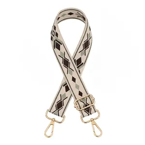 Detailed view of ethnic geometric pattern strap with polished gold-tone metal lobster hooks