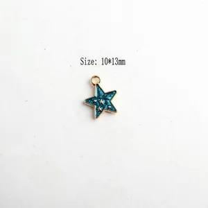 Detailed view of 10x13mm gold star charm with blue oil drip finish for DIY jewelry