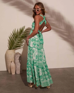 Detail of cross back tie design and tiered ruffled hem on green tropical print dress