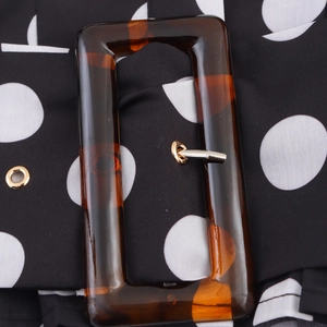 Vintage-Damenbluse mit Polka-Dots und dekorativer bernsteinfarbener Gürtelschnalle