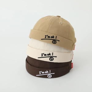 Trio of cotton Miki hats for kids with 'I'm ok' smiley face embroidery in neutral colors