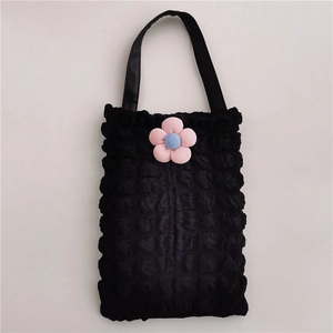 Close-up of black bubble textured fabric car tissue box cover with a 3D floral accent