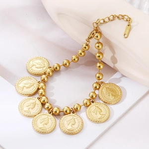 Gold stainless steel bead chain bracelet with seven Elizabeth II coin charms on white background