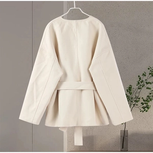 Back view of a creamy white wool coat with a matching waist belt on a minimalist hanger