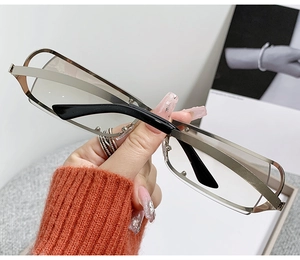 Detail of silver steampunk oval sunglasses with hollow metal frame and black temples