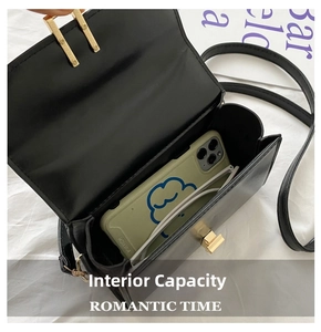 Internal capacity of black leather crossbody bag showing space for smartphone and glasses