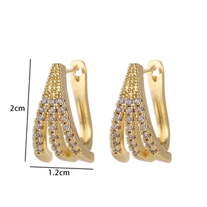 Detailed view of gold plated J-shaped earrings with triple row cubic zirconia stones