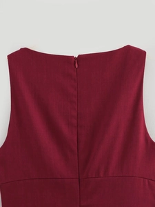Detail of burgundy sleeveless dress featuring a seamless back zipper and refined seams