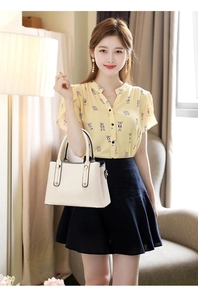 Elegant cream white faux leather handbag for women styled with casual home outfit