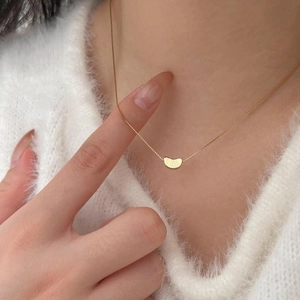 Elegant 925 sterling silver bean pendant necklace in gold finish worn by model