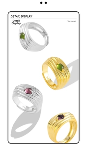Detail view of S925 sterling silver wavy rings with oval inlaid stones and metal hallmarks