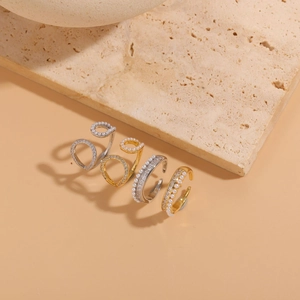 Detail showing 14K gold plated geometric rings with pearls and zircon stones