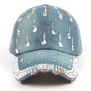 Detail of denim baseball cap with crystal rhinestones and distressed brim with studs