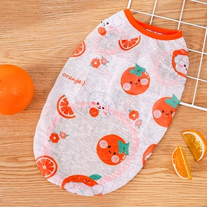 Detail of mesh pet vest with orange prints and breathable fabric on wood texture